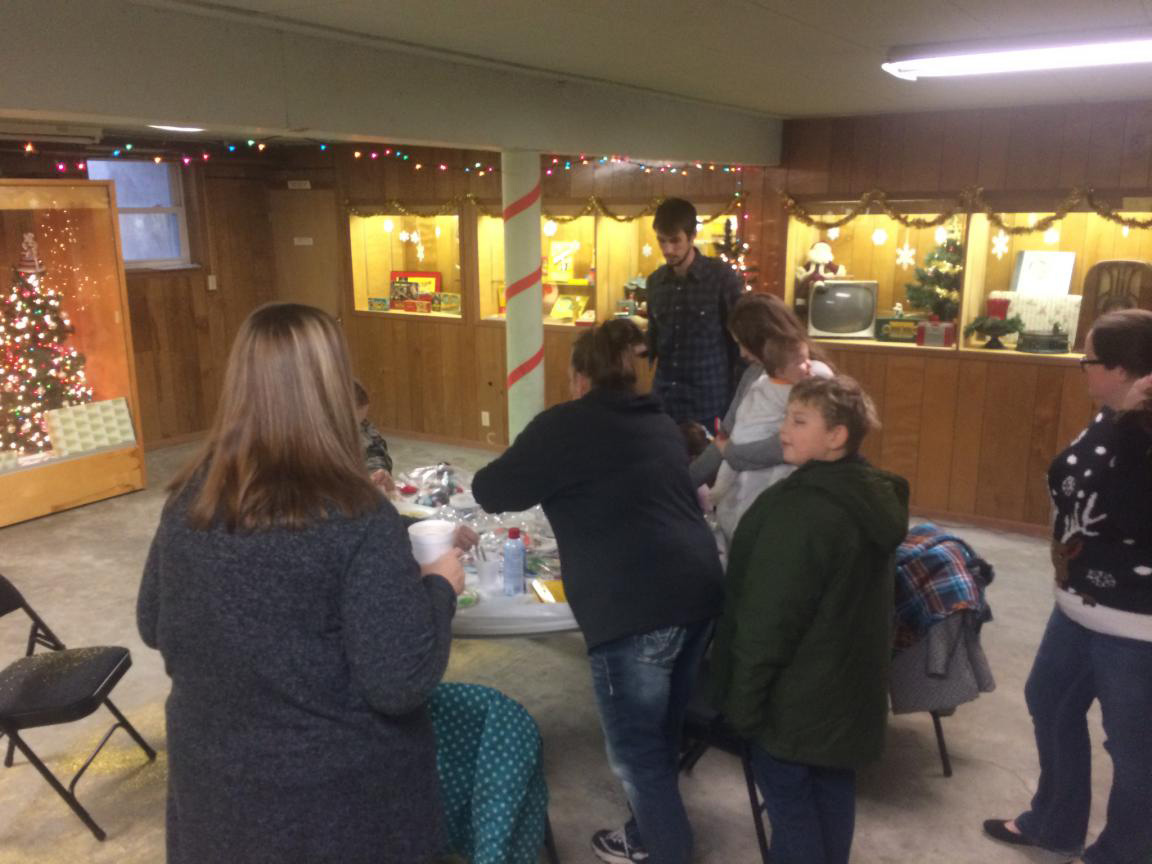 color photo of a group of people gathered around a table